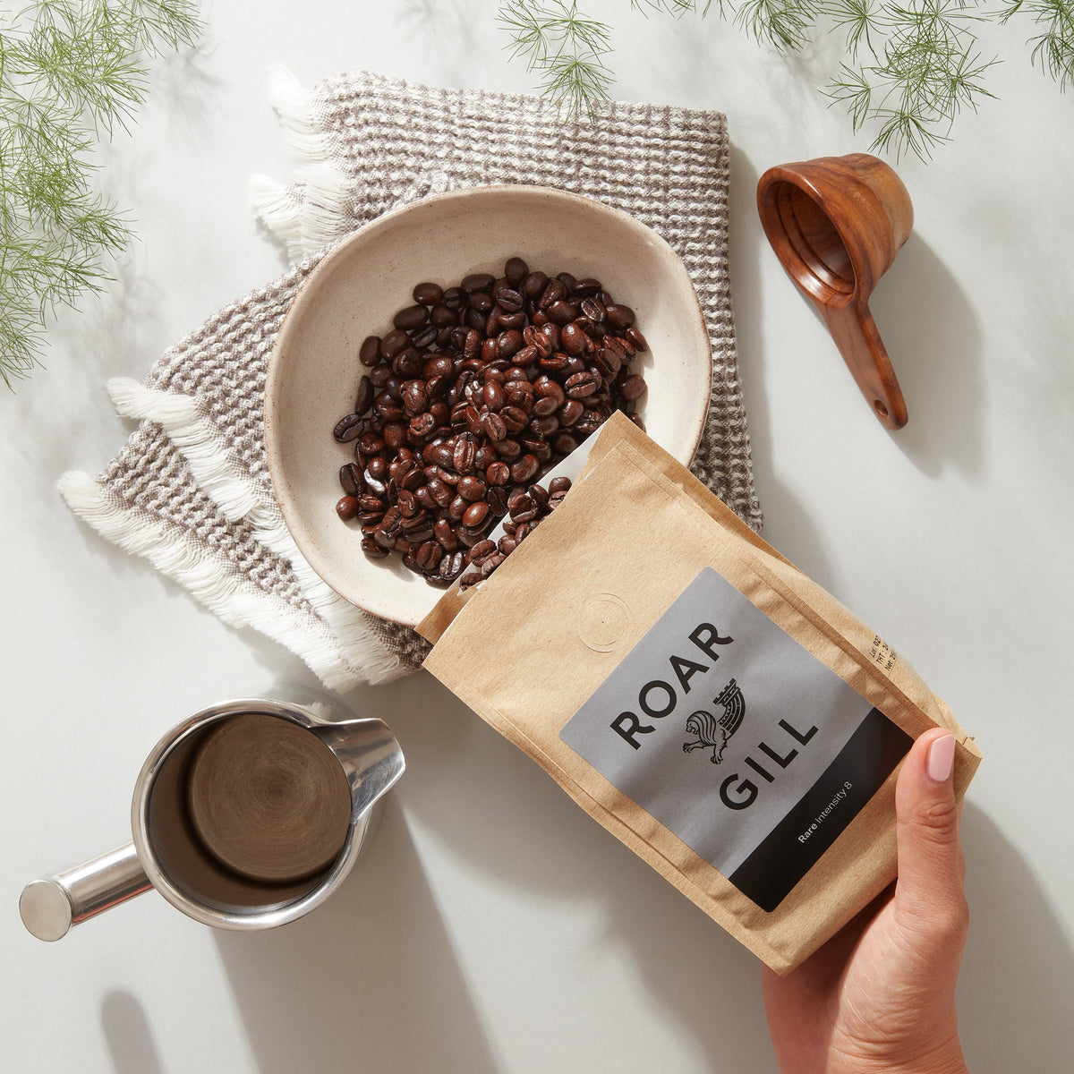 rare whole coffee beans being poured into bowl