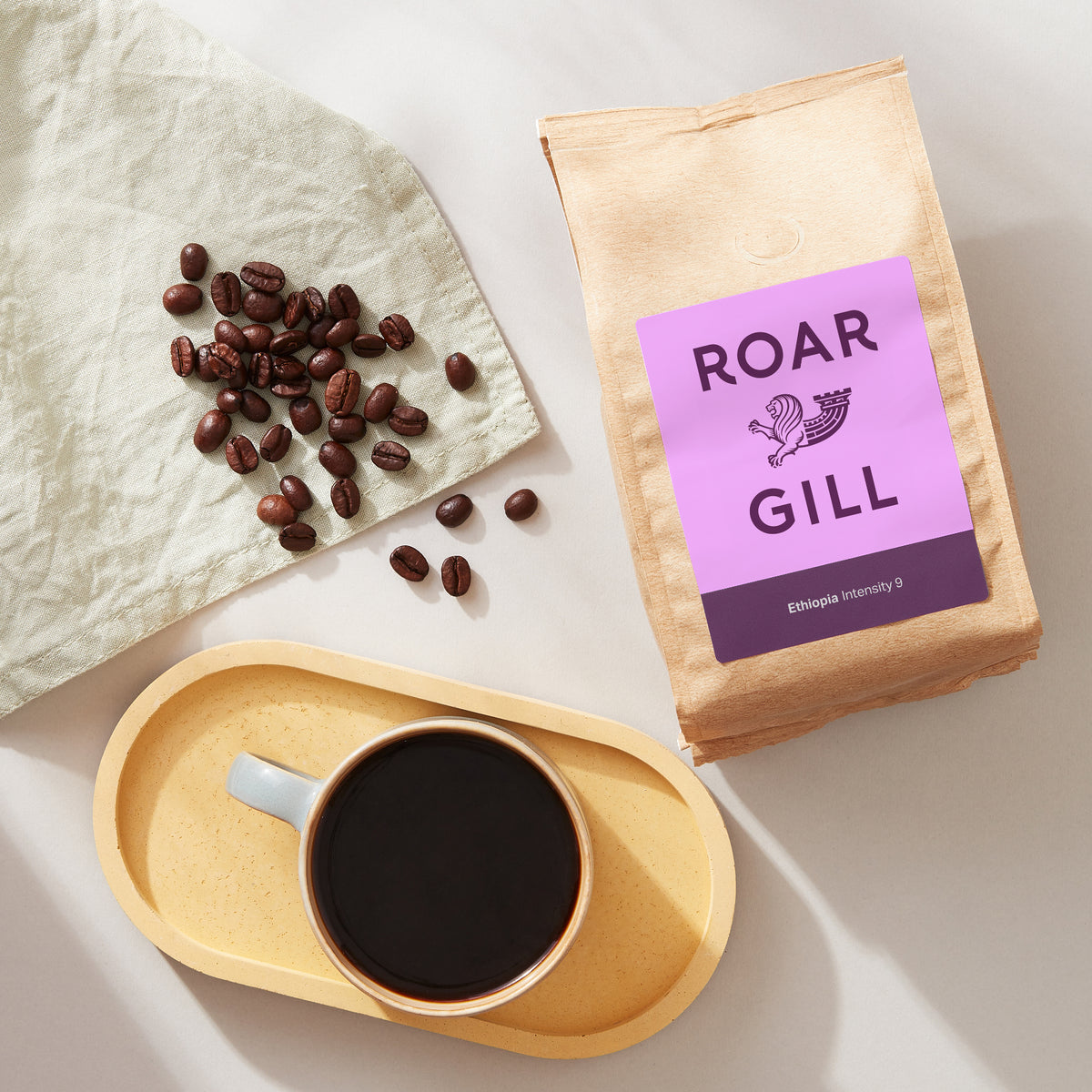 Ethiopia Whole Coffee Beans next to a poured long black in  coffee mug