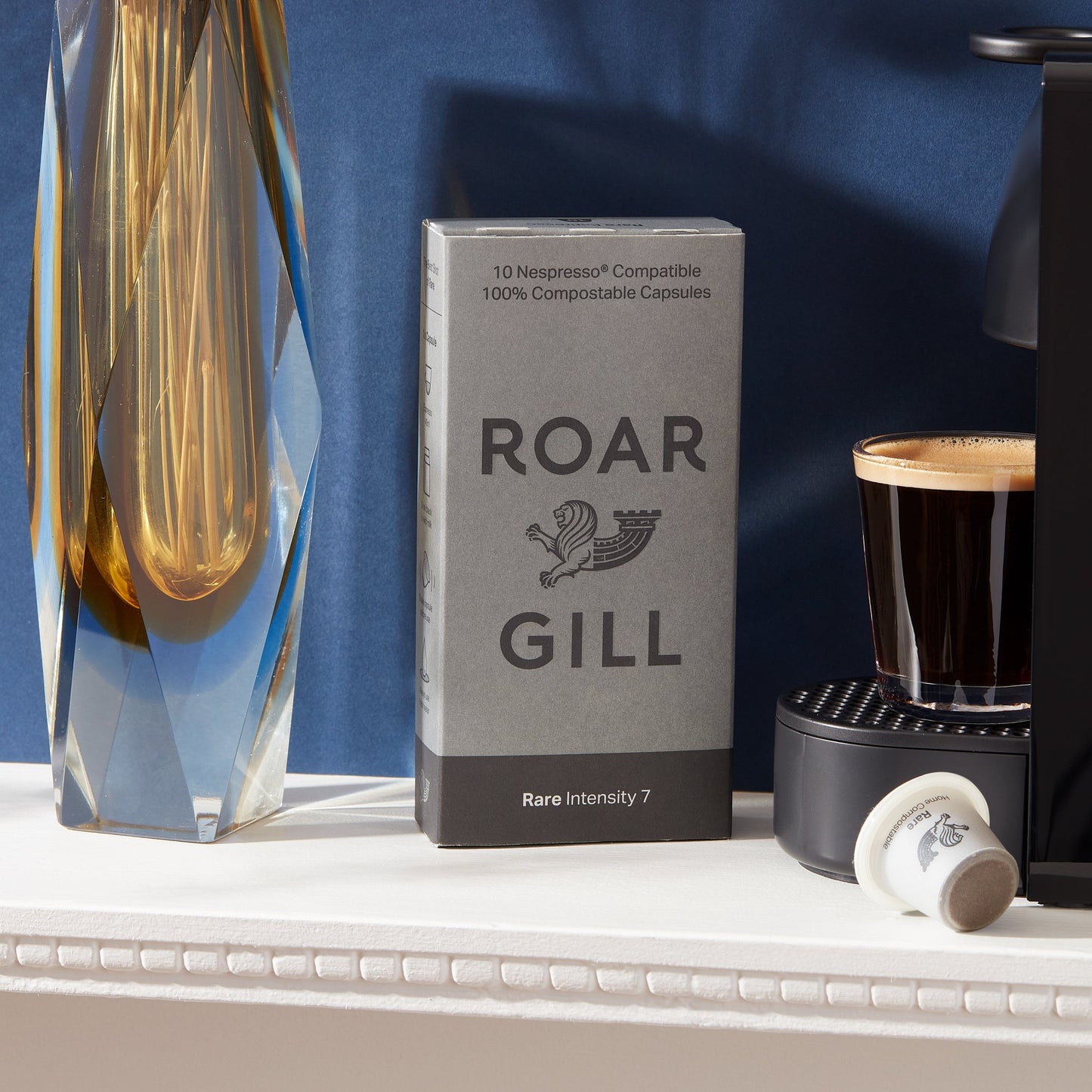 Roar Gill Rare Box Standing Next to Krups Coffee Machine.